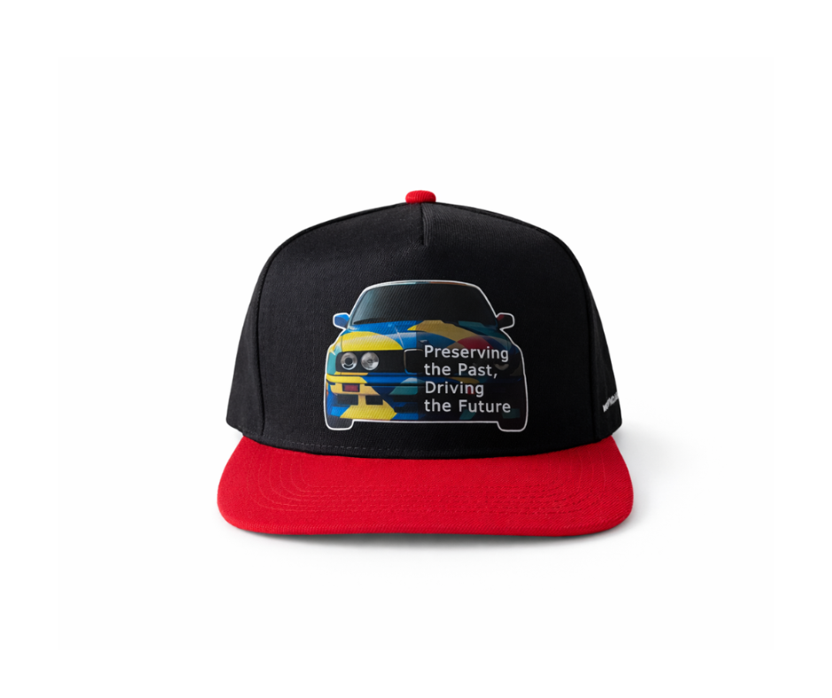 Black and red cap with car graphic of BMW E30 and text Preserving the Past Driving the Future, vasarine kepure su E30